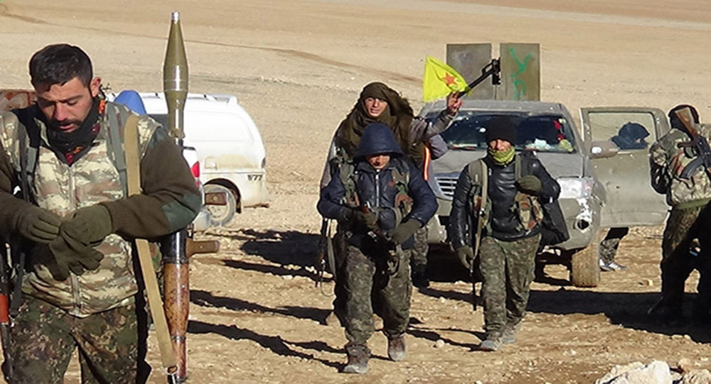 Боец СДС показывает турецкое оружие, захваченное у ИГИЛ